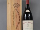 a bottle of wine in a wooden box next to a wooden box
