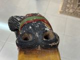 a wooden sculpture of a fish that is on a table