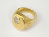 an image of a gold ring with a square stone in the center