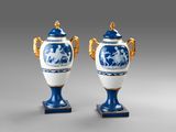 pair of blue and white vases with gold handles and handles