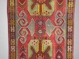 a red and green rug with geometric designs on it