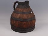 a large wooden barrel with a handle on a table