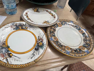 four plates sitting on a table with a water bottle