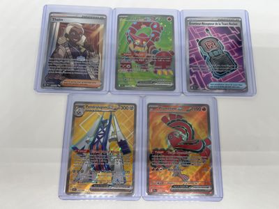 four different pokemon trading cards in plastic cases on a white surface
