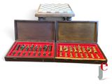 two cases with chess pieces in them on a white surface