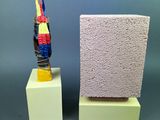 two small sculptures of a bird on a block and a small sculpture of a bird on a block