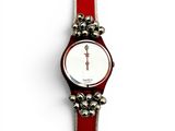 an image of a wrist watch with bells attached to it ' s strap