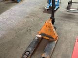 a fork lifter sitting in the middle of a warehouse floor