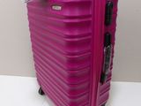 a pink suitcase sitting on a white surface