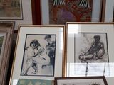 a lot of framed pictures on the table
