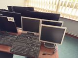 three computer monitors and a keyboard on a desk