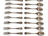 a lot of spoons and forks on a white surface