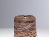 a close up of a small wooden container on a table
