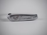 a silver knife that is laying on a table