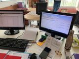 a desk with two computer monitors and a keyboard on it