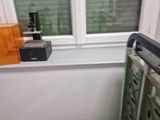 a pink purse sitting on the floor next to a window