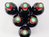 six bottles of wine are arranged in a circle on a white surface