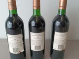three bottles of wine that are sitting on a table