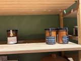 a shelf with jars of jams and jars of preserves on it