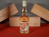 a bottle of liquor sitting on a table next to a wooden box