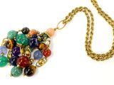 a gold chain with a multicolored necklace on it