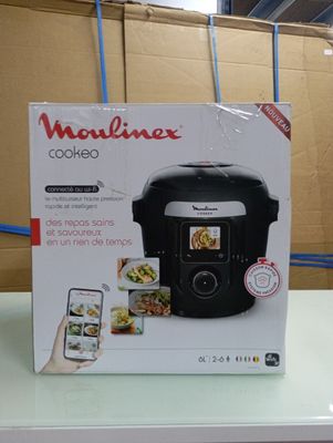 packaging of a black rice cooker sitting on top of a counter