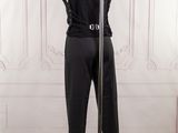 the mannequin is standing on a pole in front of a white wall