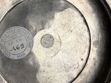 a silver plate with a metal lid on a table