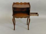 a small wooden desk with a drawer on top of it
