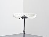 an image of a white stool sitting in a corner