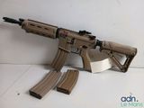 the toy gun is laying on the floor next to the magazines