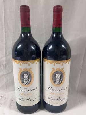 two bottles of red wine sitting next to each other on a table