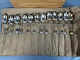 a lot of spoons and forks in a roll