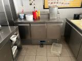 a large stainless steel kitchen with a lot of counter space