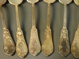 five spoons that are sitting next to each other on a table