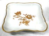 a white plate with a yellow flower design on it