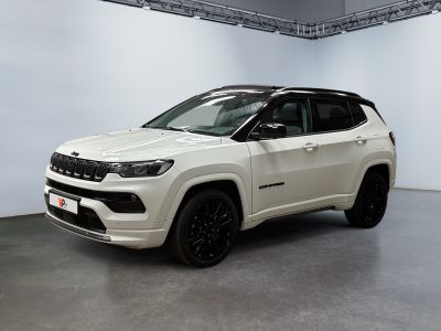 the white jeep compass is parked in a large room