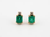 a pair of emerald and diamond earrings