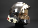silver and gold helmet on a black stand against a black background
