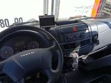 a steering wheel and dashboard of a truck on the street