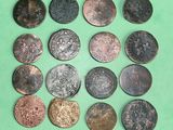 several different types of coins are arranged on a green surface