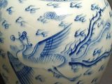 a blue and white vase with a bird design on it