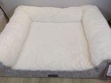 a dog bed that is on the floor in the room