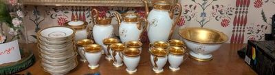many vases on a table with a mirror in the background