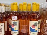 several bottles of wine are lined up on a counter