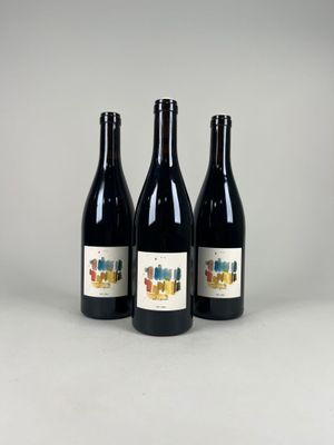 three bottles of wine sitting next to each other on a table
