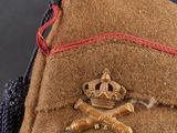 a close up of a brown hat with a red ribbon