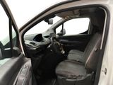 the interior of a car with the door open and the driver ' s seat down