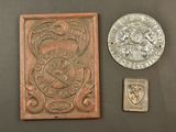 two coins and a coin sitting next to each other on a table