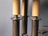 three candles that are sitting on a metal plate